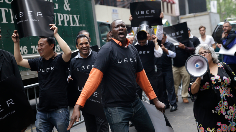 Uber drivers and their supporters protest in front of the offices of the Taxi and Limousine Commission in New York, Thursday, May 28, 2015.